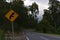 Upcoming intersection in bending road traffic road sign in yellow and black color