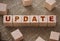 Update word on a wooden cubes on burlap canvas background. Business technologies manufacturing concept