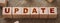 Update word on a wooden cubes on burlap canvas . Business technologies concept