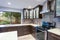 Updated contemporary kitchen room interior in white and dark tones.