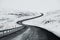 Uphill road landscape in winter at Iceland. Asphalt road with sideways full of snow