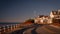 Uphill road with shadows and houses on Cape Cod coastline at Sunrise