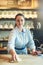 She upholds spotless standards in her cafe. a young woman cleaning a countertop in her cafe.