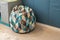 Upholstered bean bag or pear-shaped chair with filling, with geometric patterns, triangles, in children`s room. Neutral tones. Con