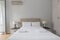Upholstered bedroom headboard with two white pillows,