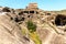 Uplistsikhe, Georgia - June 14, 2016: Tourists visiting Ancient Orthodox Church and Cave Town Uplistsikhe in Georgia