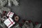 Upper, above, top view of pine, evergreen, and Christmas red glass toys, presents on stone background.