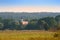 Upper Bavarian autumn landscape with small church in morning mist forest