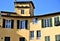 Upper detail, silhouetted in the blue sky, of one of the historic and typical houses of the amphitheater square in Lucca.