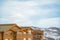 Upper exterior of houses against snow covered mountain and cloudy sky in winter