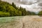 Upper Kitimat River, glacial green river, on a cloudy summer day