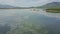 Upper panorama sky clouds reflection in lake with sand island