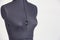 Upper part of blue female sewing mannequin on gray background, s