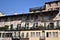 Upper part of the frescoed and sunlit facades of ancient buildings in Piazza delle Erbe in Verona.