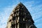 The upper part of one of the towers of the Angkor temple complex. The architectural art of the ancient Khmer