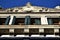 Upper part, outlined by the blue sky and illuminated by the sun of a winter afternoon, of a historic building in Padua.