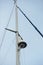 Upper part of a white luxury yacht with the navigational equipment on blue sky with clouds