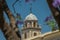 The upper platform and the dome of the bell tower of the Cathedral close-up. View through a flowering jacaranda. Jerez de la Front