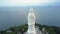 Upper round motion huge white buddha statue on ocean coast