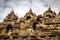 The upper section of the Borobudur Buddhist temple and clouds, Indonesia