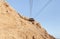 The upper  station of the cable car station at the top of the mountain, with the ruins of the Massada fortress in Israel