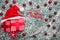 Upper, top, view from above of, evergreen red toys, Christmas presents and Santa hat on gray marble background