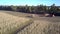 Upper view corn combine and truck rest on harvested field