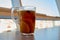 Upper view of glass cup of hot tea with herbs, fruit and berries