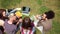 Upper view of group of college friends enjoying sunny day in campus.