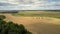 Upper view harvesters and trucks stand on wheat field