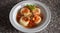 Upper view of one plate of sorrentinos - stuffed pasta - with sauce, parmesan cheese, and decorated with some parsleyÂ´s leaves