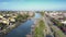 Upper view people cross blue river on white bridge by palms