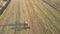 Upper view square baler collects straw on harvested field