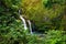 Upper Waikani Falls also known as Three Bears, a trio of large waterfalls amid rocks & lush vegetation with a popular swimming hol