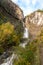 Upright photography of Cascada de Sorrosal Sorrosal waterfall with yellow autumn trees foreground in Broto