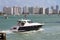 Upscale cabin cruiser and Miami Beach condo skyline