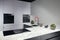 Upscale modern flat design loft kitchen with Induction cooker black glass hob with integrated hood or aspirating
