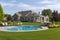 upscale ranch house with manicured lawn, swimming pool, and gazebo
