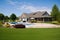 upscale ranch house with manicured lawn, swimming pool, and gazebo