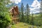 An upscale rural log home on a hillside in the mountains near Sandpoint, Idaho, USA, during summer