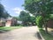 Upscale suburbs residential area with solar panel roof house and tall trees near Dallas, Texas, USA