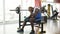 Upset African-American sportsman sitting on training equipment at the gym