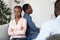 Upset African American Spouses Sitting Back To Back At Marriage Therapy Session