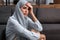 Upset arabian woman in hijab touching