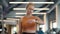 Upset athlete girl using smartwatch at gym. Sportswoman standing in sport club