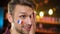 Upset bearded football fan with french flag on cheek making facepalm team losing