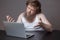 Upset Bearded Man in shirt sitting beside notebook. Man waving hands and look in notebook