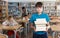 Upset boy standing with books