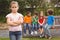 Upset child standing away from group