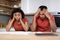 Upset despaired millennial african american wife and husband in same t-shirts think and work with documents